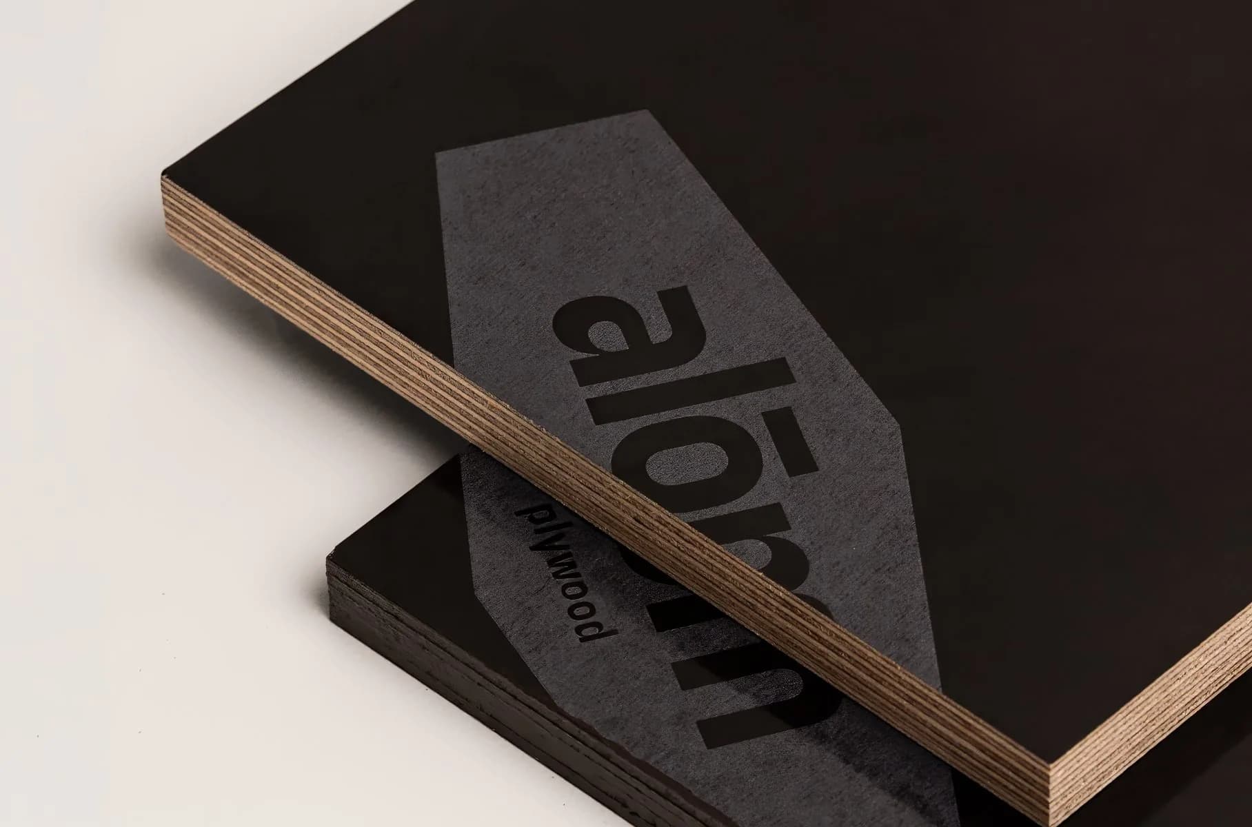 A film-faced plywood sheet with ALOM branded film